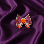 Bow Shaped Hair Clip With Orange Pompom