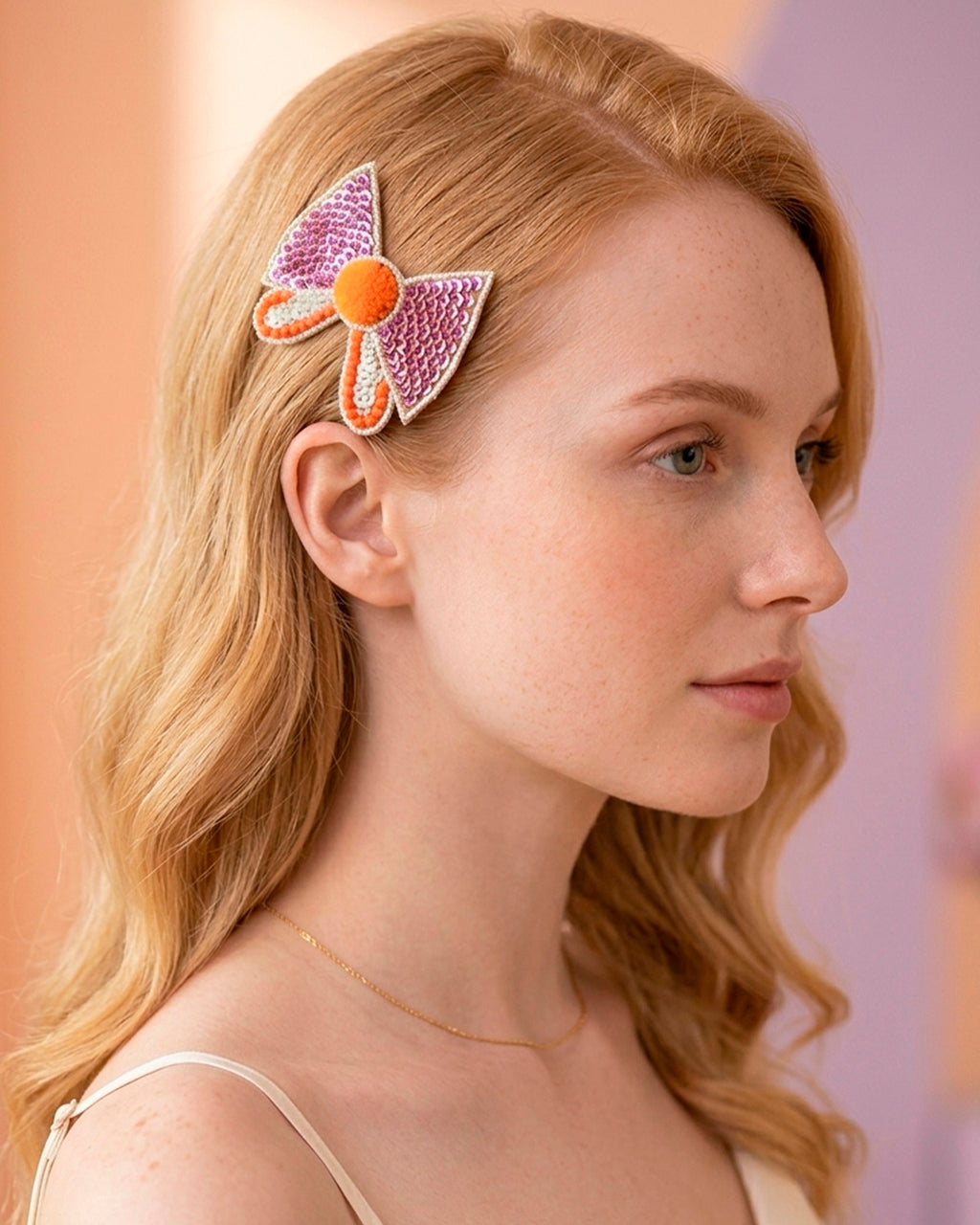Bow Shaped Hair Clip With Orange Pompom