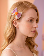 Bow Shaped Hair Clip With Orange Pompom