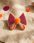 Bow Shaped Hair Clip With Orange Pompom